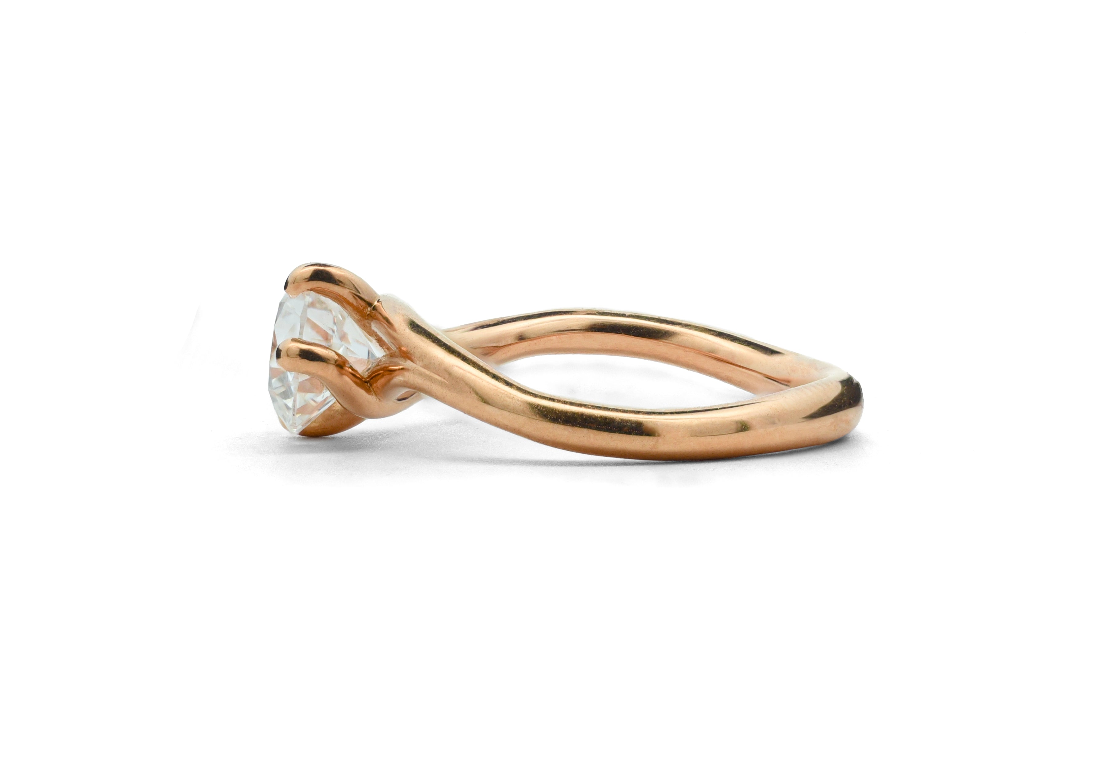 Rose gold Embrace ring with a diamond on a white background