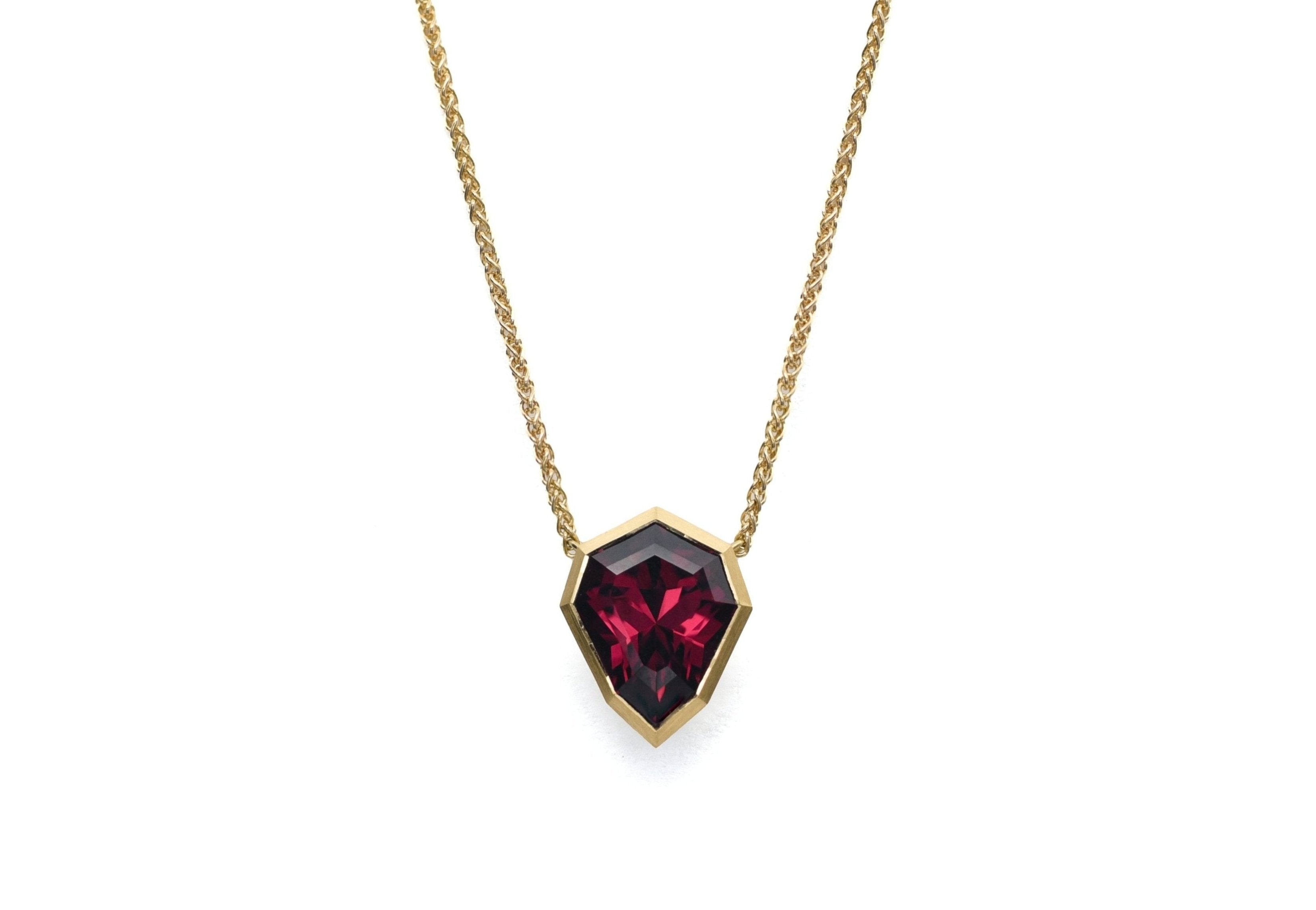 Yellow gold and shield shaped rhodolite garnet Aegis pendant