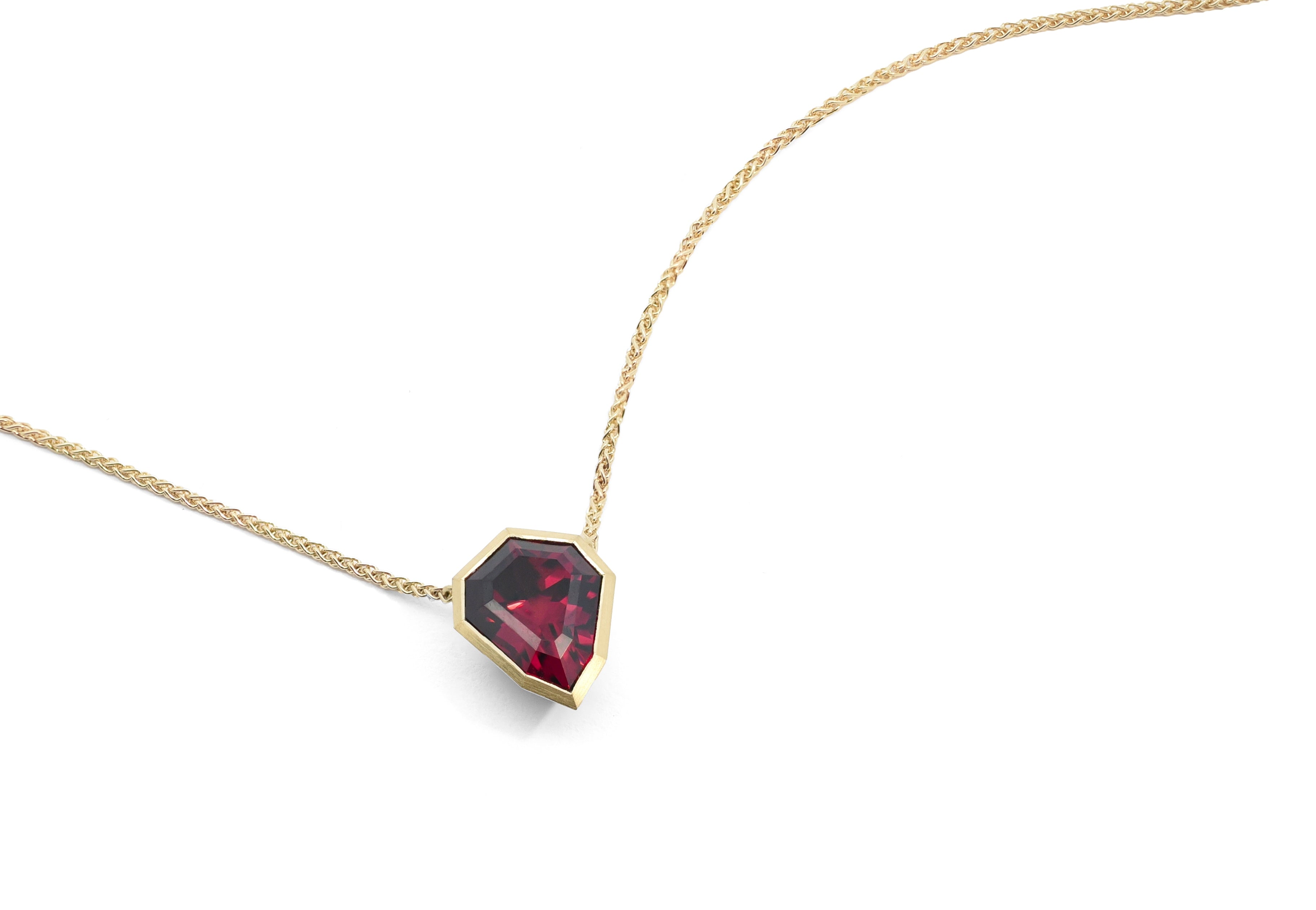 Yellow gold and shield shaped rhodolite garnet Aegis pendant