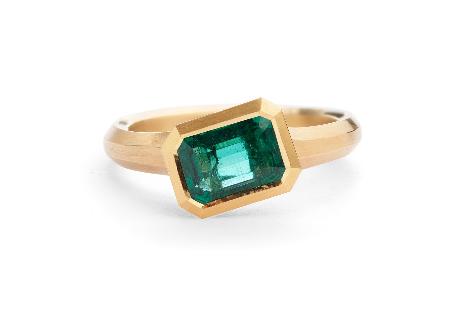 Arris carved emerald cut emerald yellow gold engagement ring