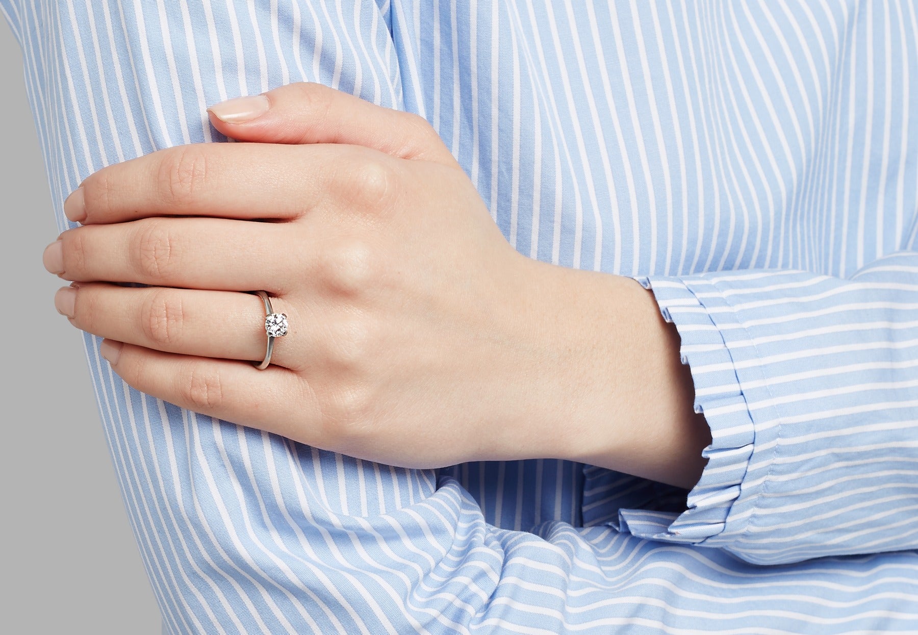 4 claw white diamond platinum engagement ring on hand