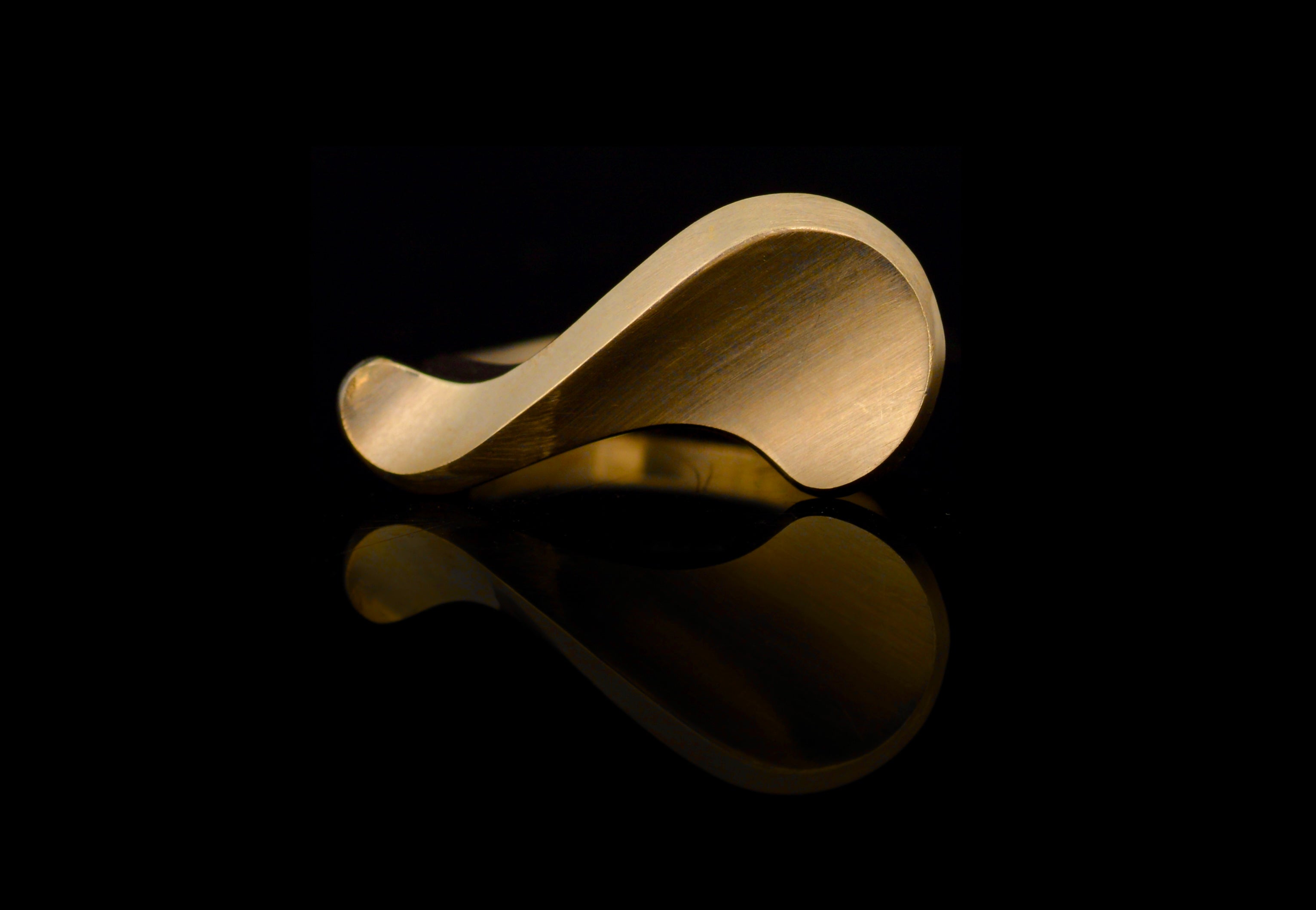 18ct yellow gold sigma ring on black background